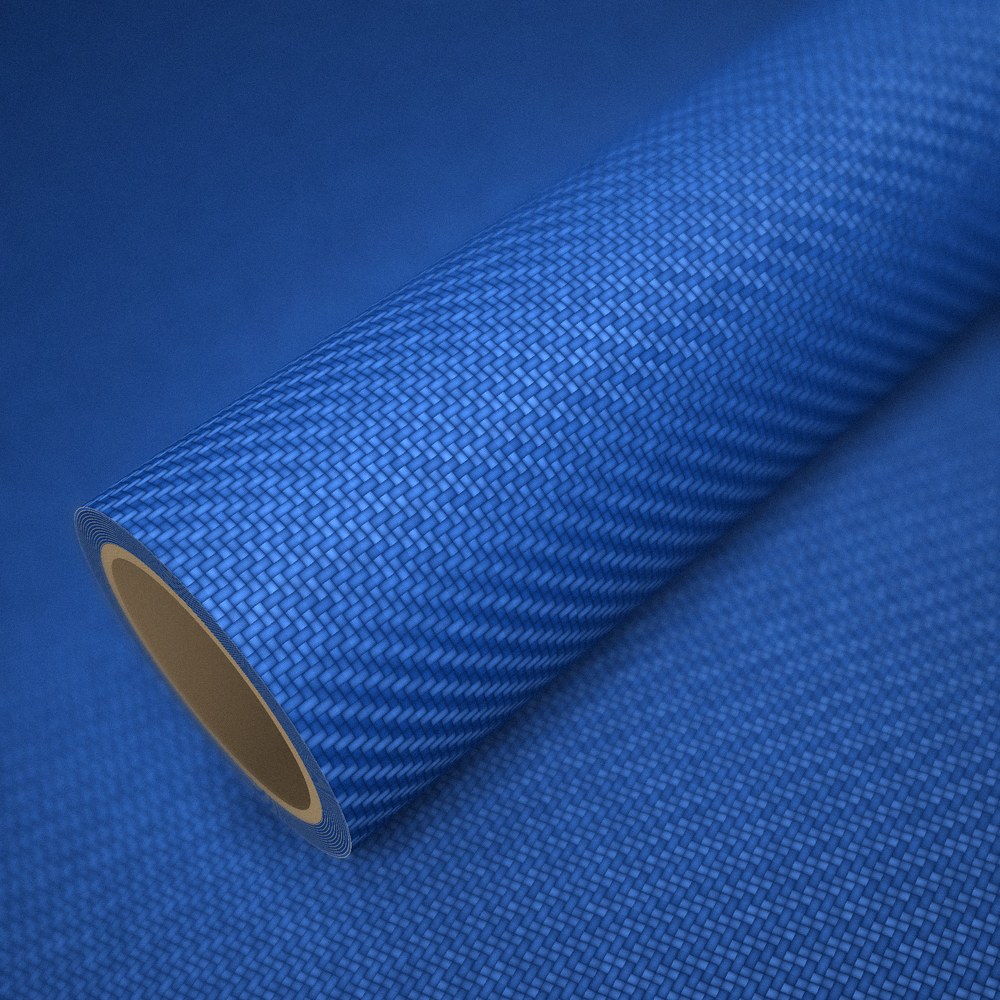 Rouleau de vinyle carbone 3D bleu posé sur une feuille du même vinyle