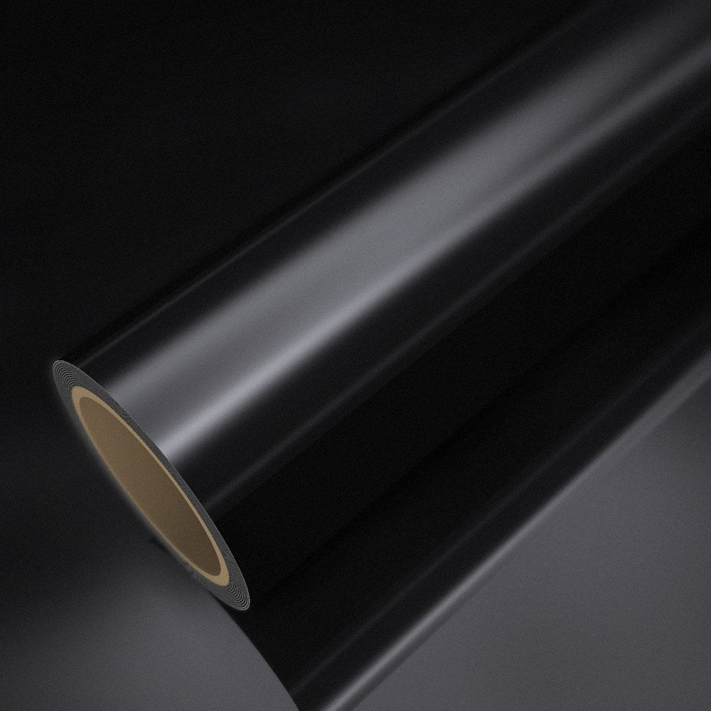 Rouleau de vinyle chrome noir posé sur une feuille du même vinyle