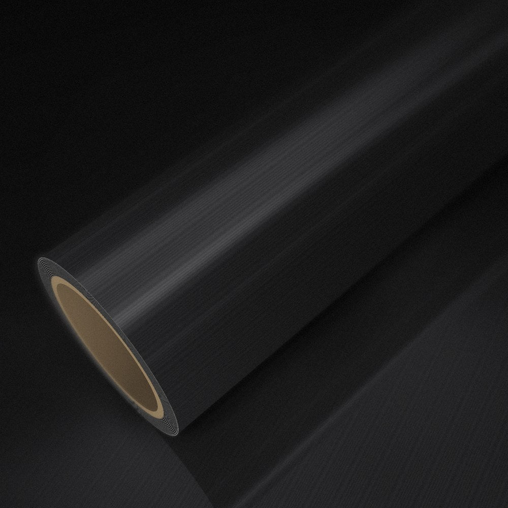 Rouleau de vinyle noir brossé posé sur une feuille du même vinyle