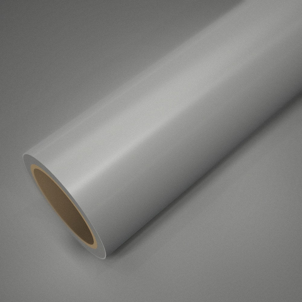 Rouleau de vinyle blanc nacré posé sur une feuille du même vinyle