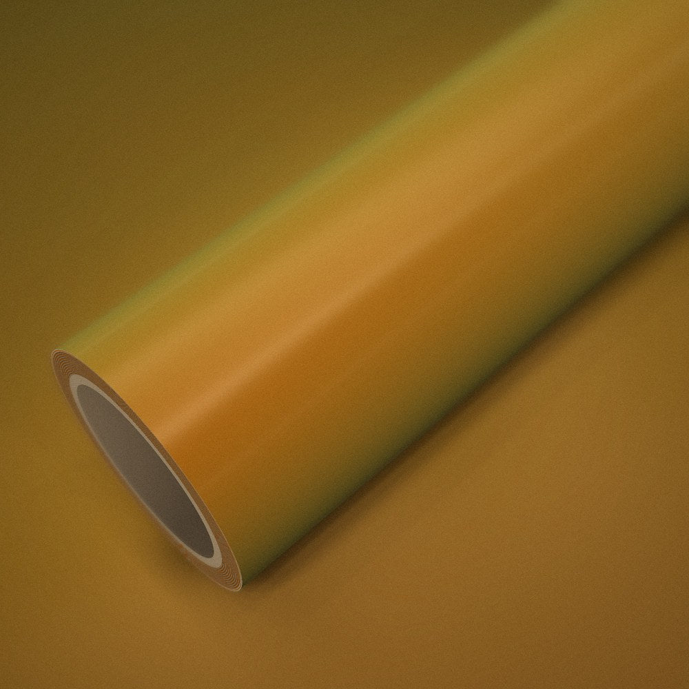 Rouleau de vinyle orange doré magique posé sur une feuille du même vinyle