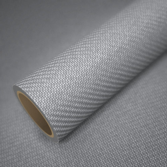 Rouleau de vinyle carbone 3D argent posé sur une feuille du même vinyle