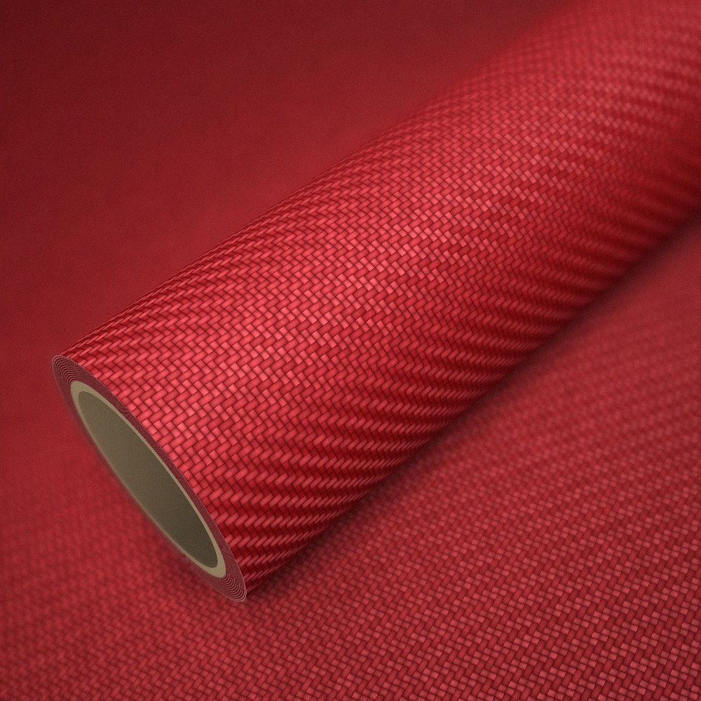 Rouleau de vinyle carbone 3D rouge posé sur une feuille du même vinyle