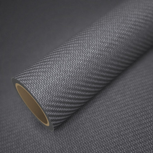 Rouleau de vinyle carbone anthracite posé sur une feuille du même vinyle