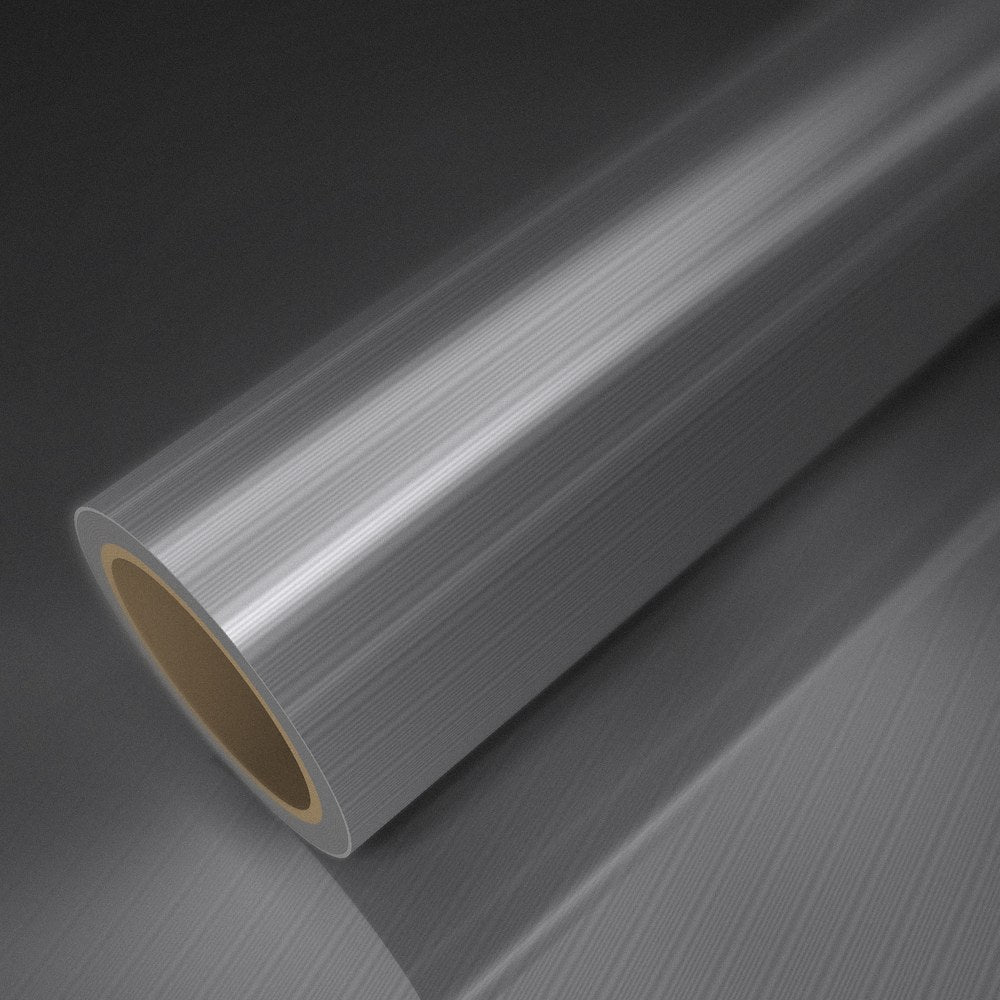 Rouleau de vinyle aluminium brossé posé sur une feuille du même vinyle