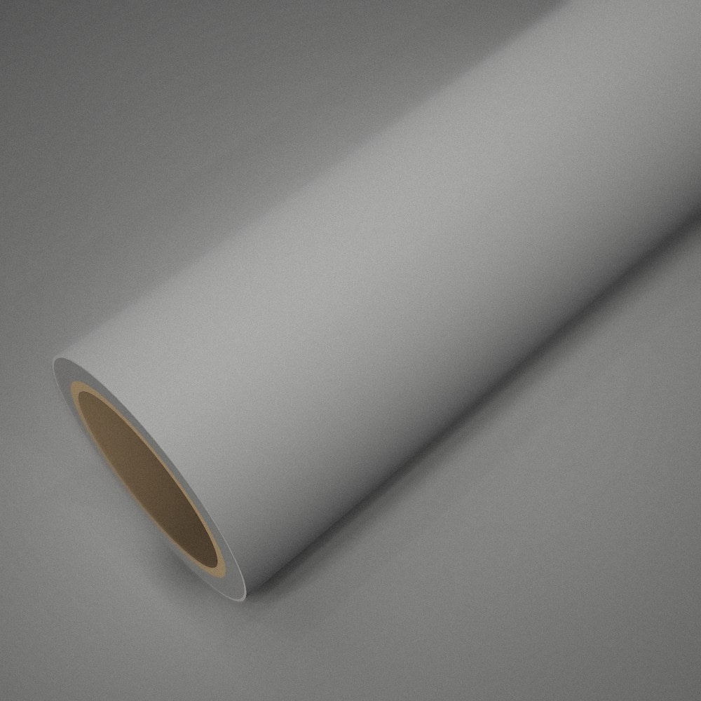 Rouleau de vinyle blanc mat posé sur une feuille du même vinyle