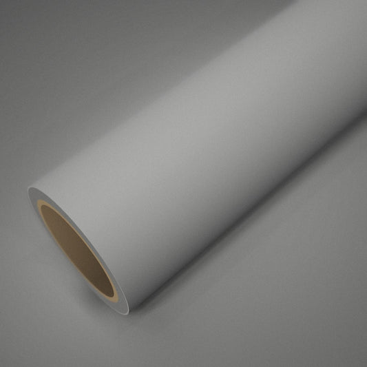 Rouleau de vinyle blanc mat posé sur une feuille du même vinyle