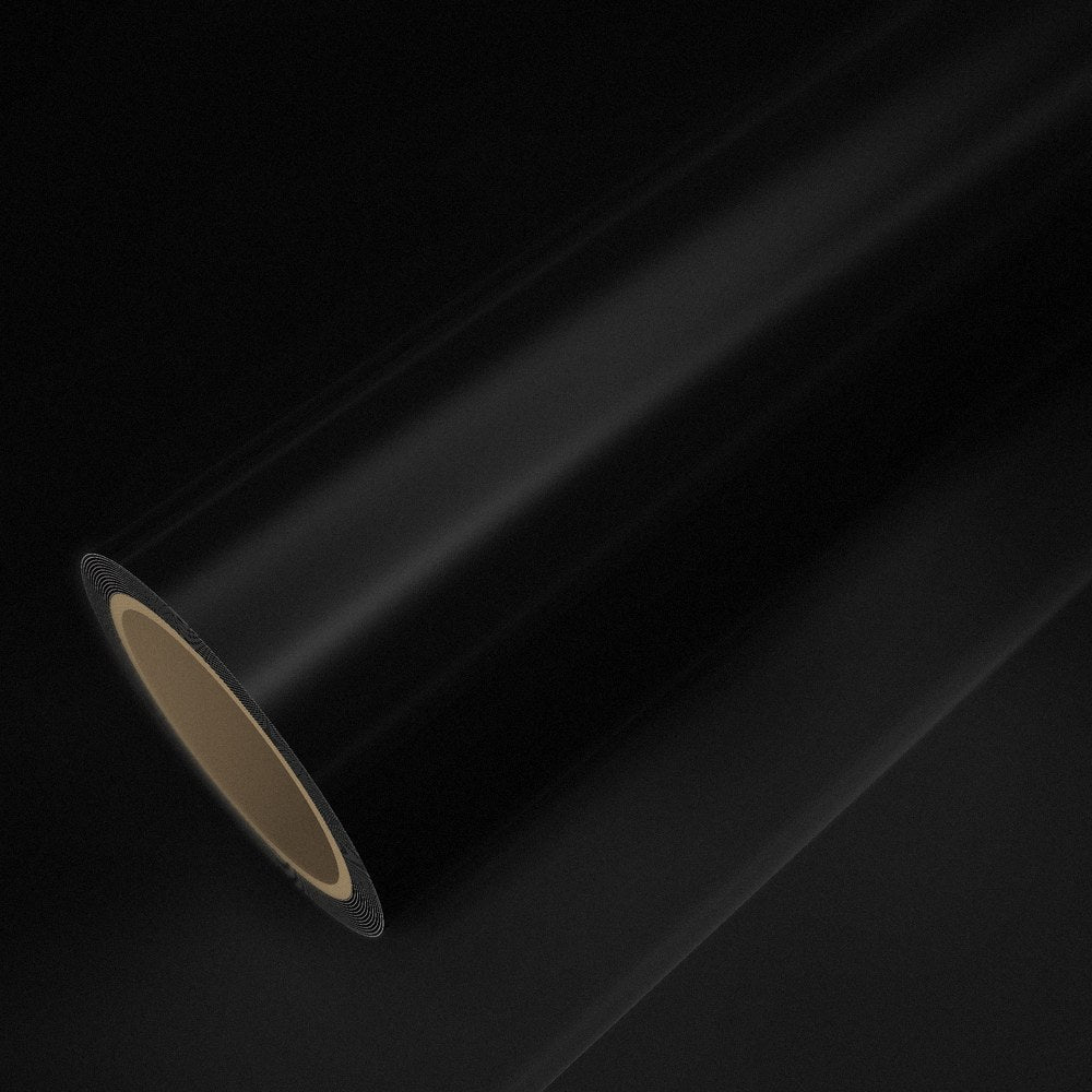 Rouleau de vinyle noir brillant posé sur une feuille du même vinyle