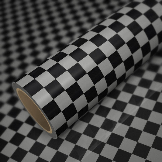 Rouleau de vinyle damier brillant (style Mini) posé sur une feuille du même vinyle